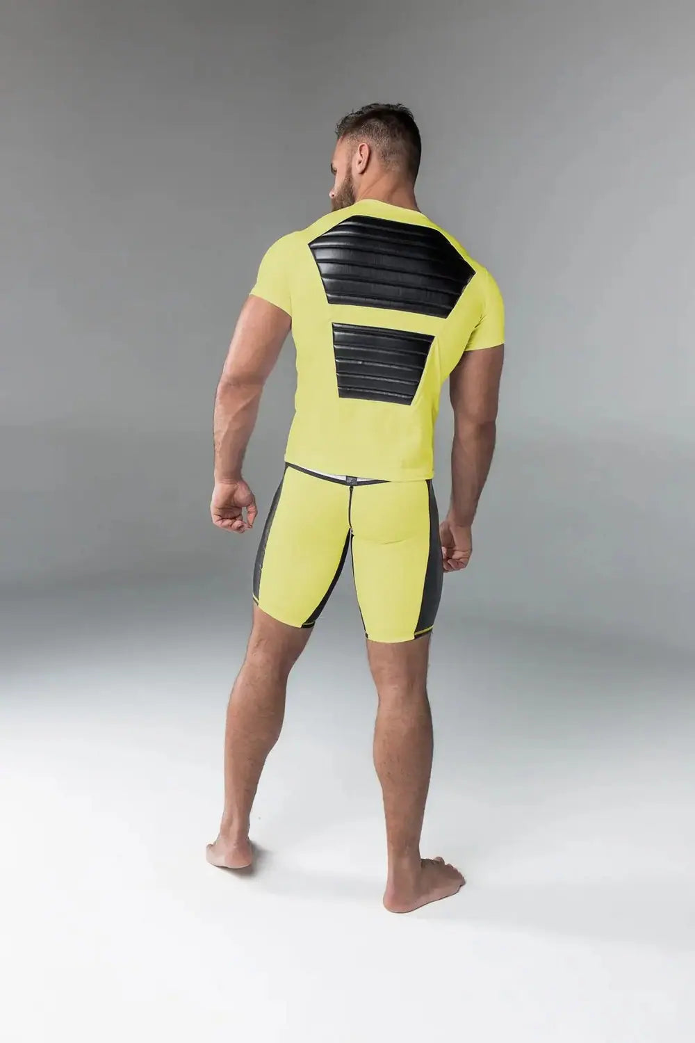 Maskulo yellow Armored T-shirt top with shiny black chest muscle pads, ideal for fitness and international party-goers